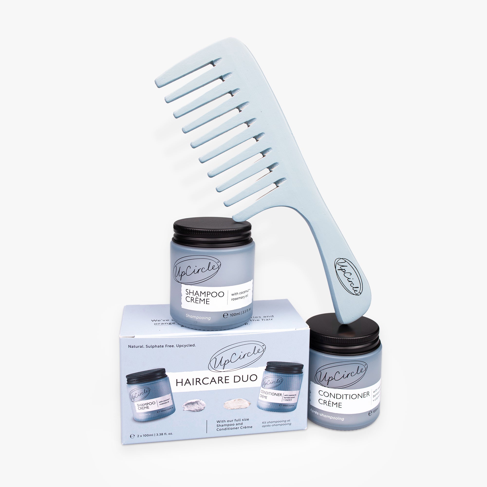 Haircare duo set with shampoos, conditioner, and comb on a white background