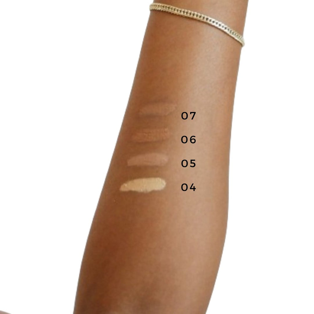 Arm with makeup swatches labeled 04 to 07 on a white background