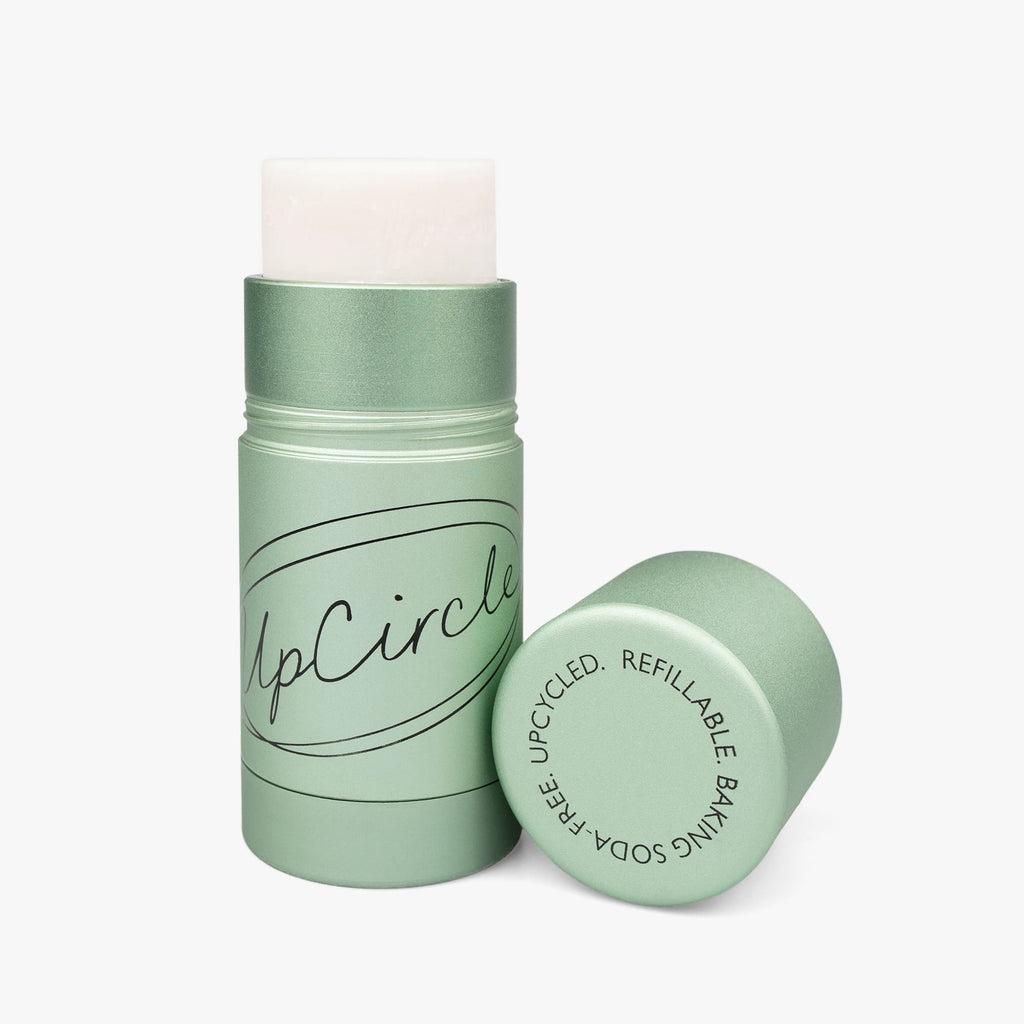 Green cylindrical container with lid on a white background