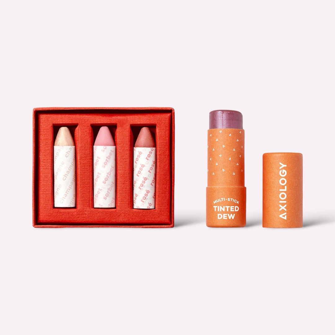 Axiology cosmetic sticks with a red box on a white background