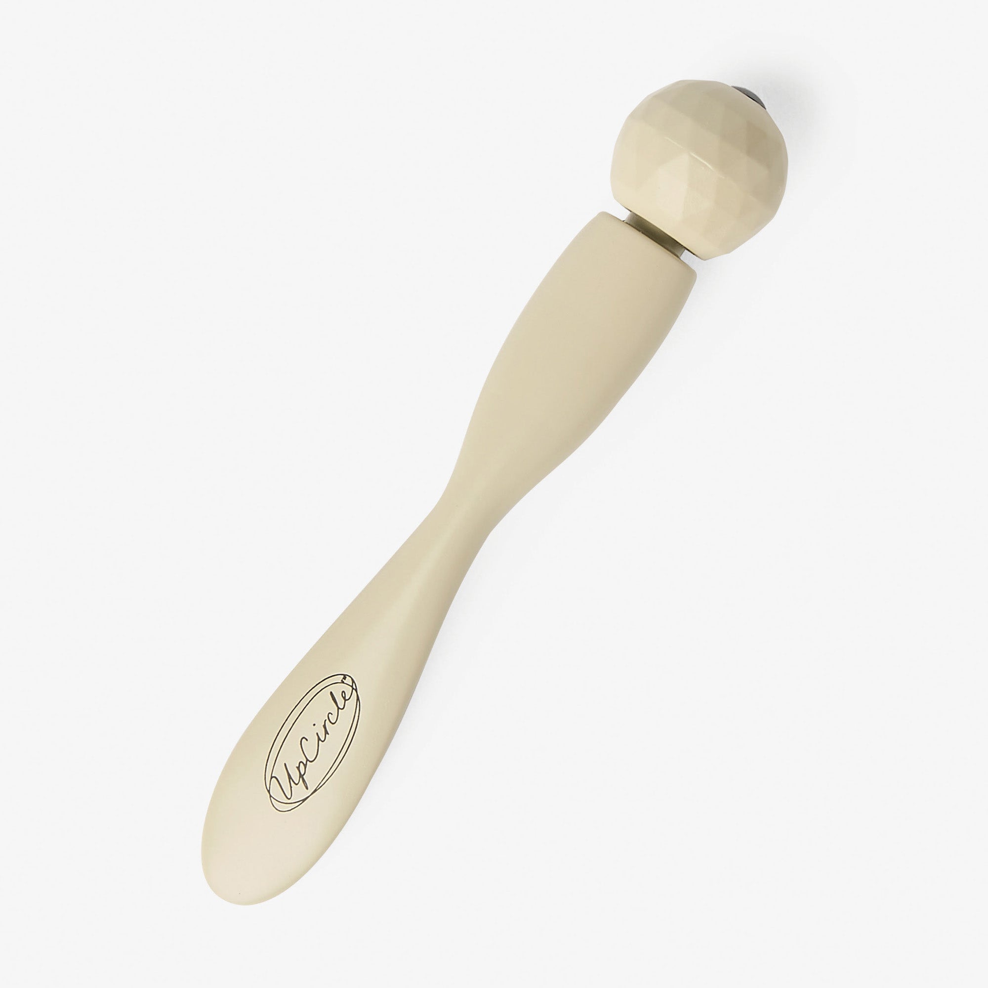 Beige handheld eye roller on a white background
