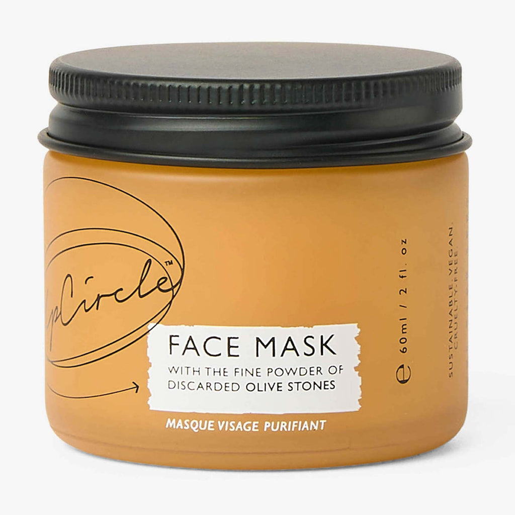 Jar of face mask with black lid on a white background