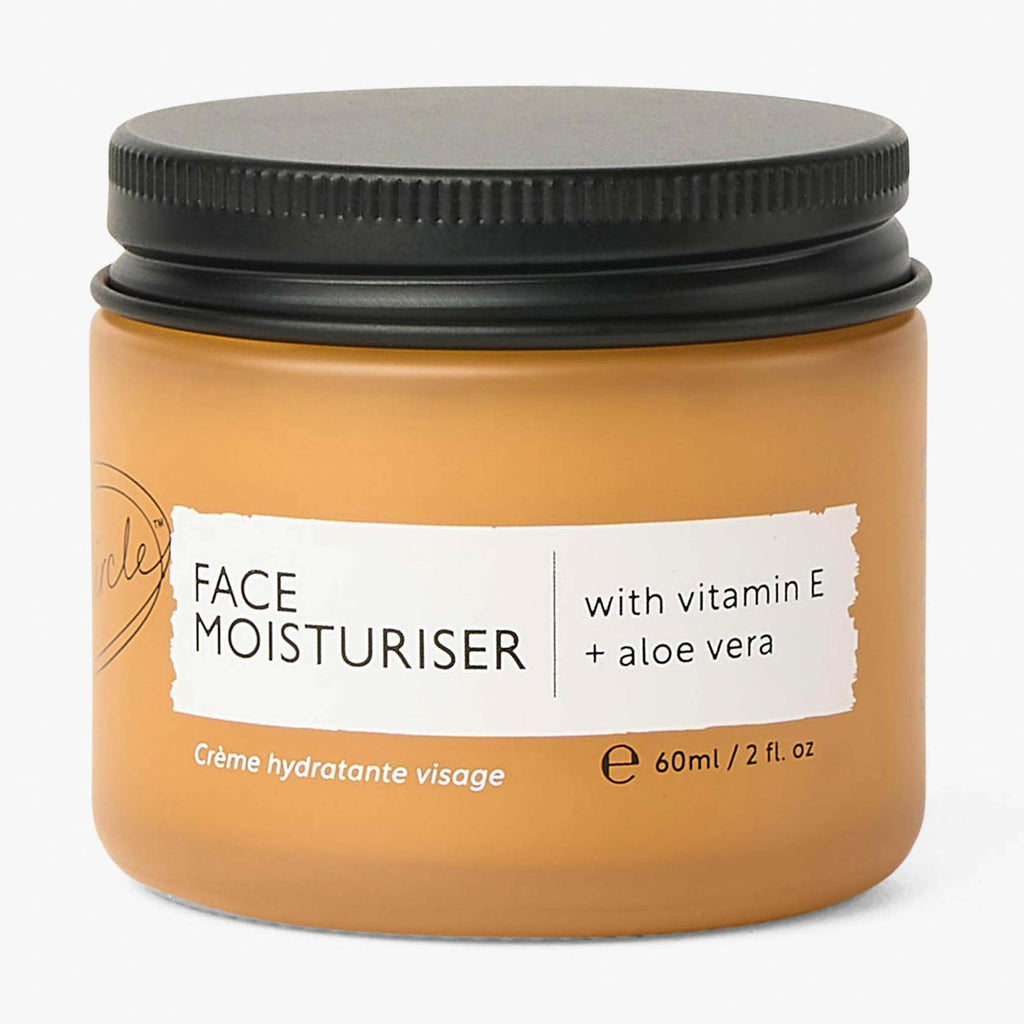 Jar of face moisturizer with black lid on a white background