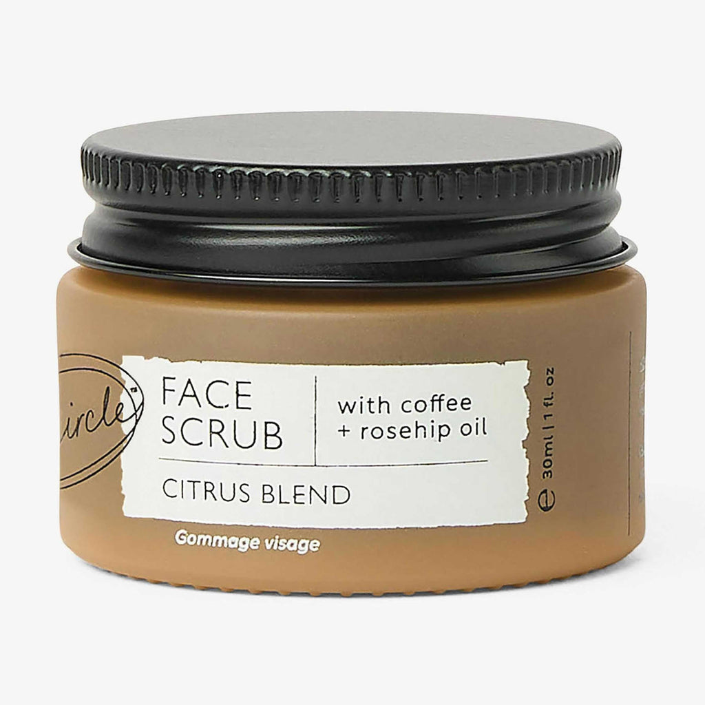 Jar of face scrub with coffee and rosehip oil on a white background