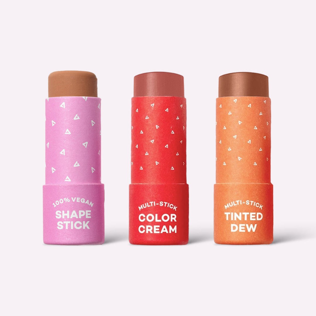 Three cosmetic sticks with different colors and text on a white background