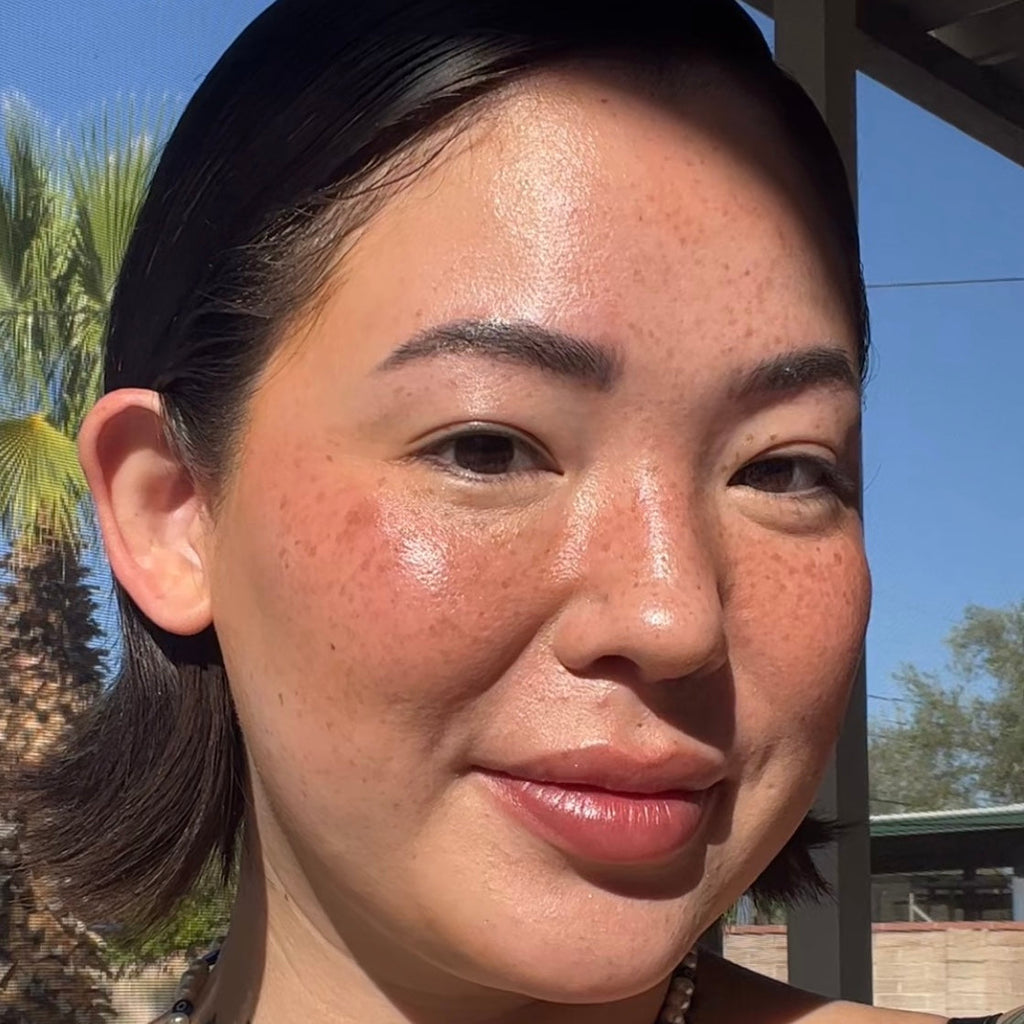 Close-up of a person wearing makeup with a blurred background