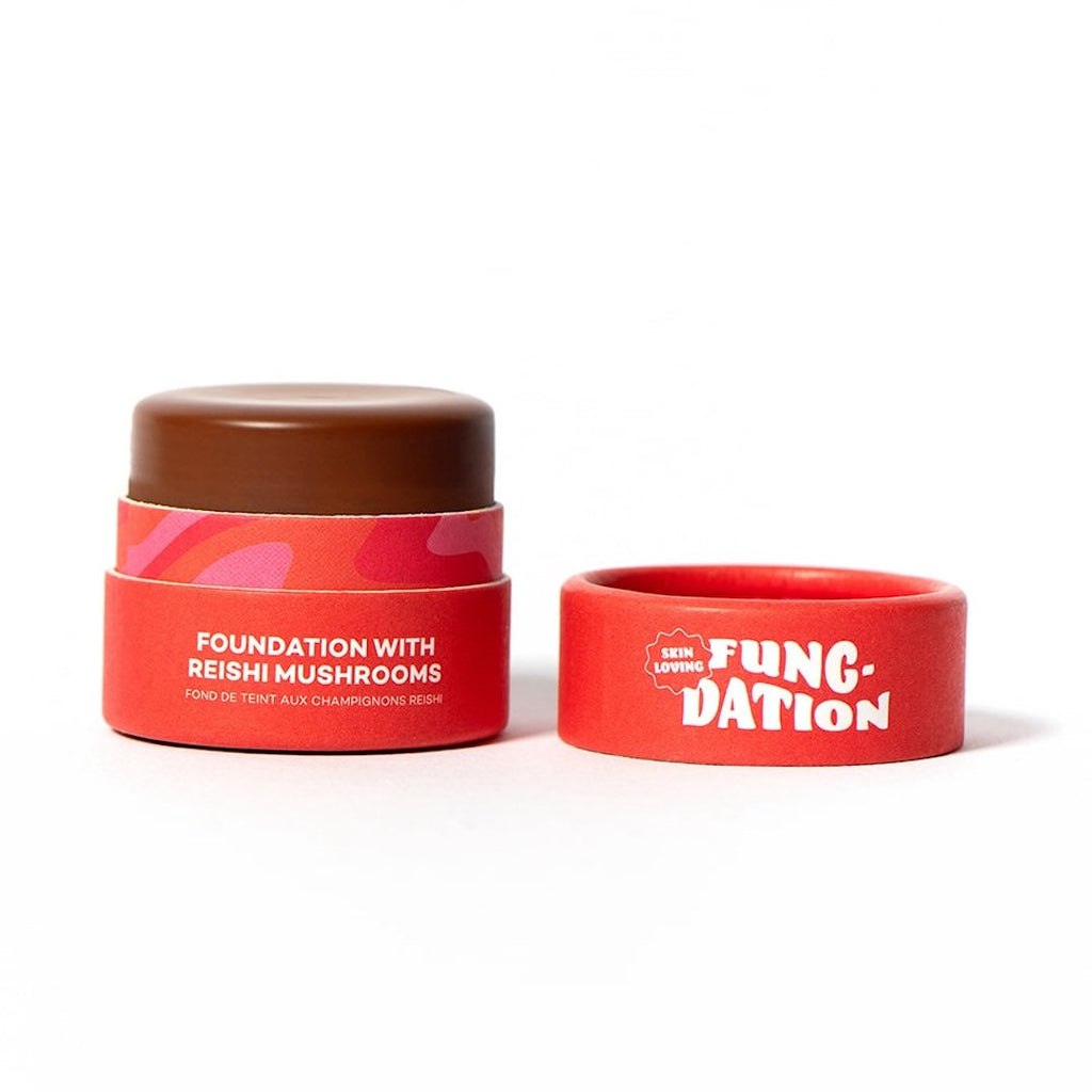 Red paper cosmetic jar with brown foundation, accompanied by a red lid with 'FUNG-DATION' text on a white background.
