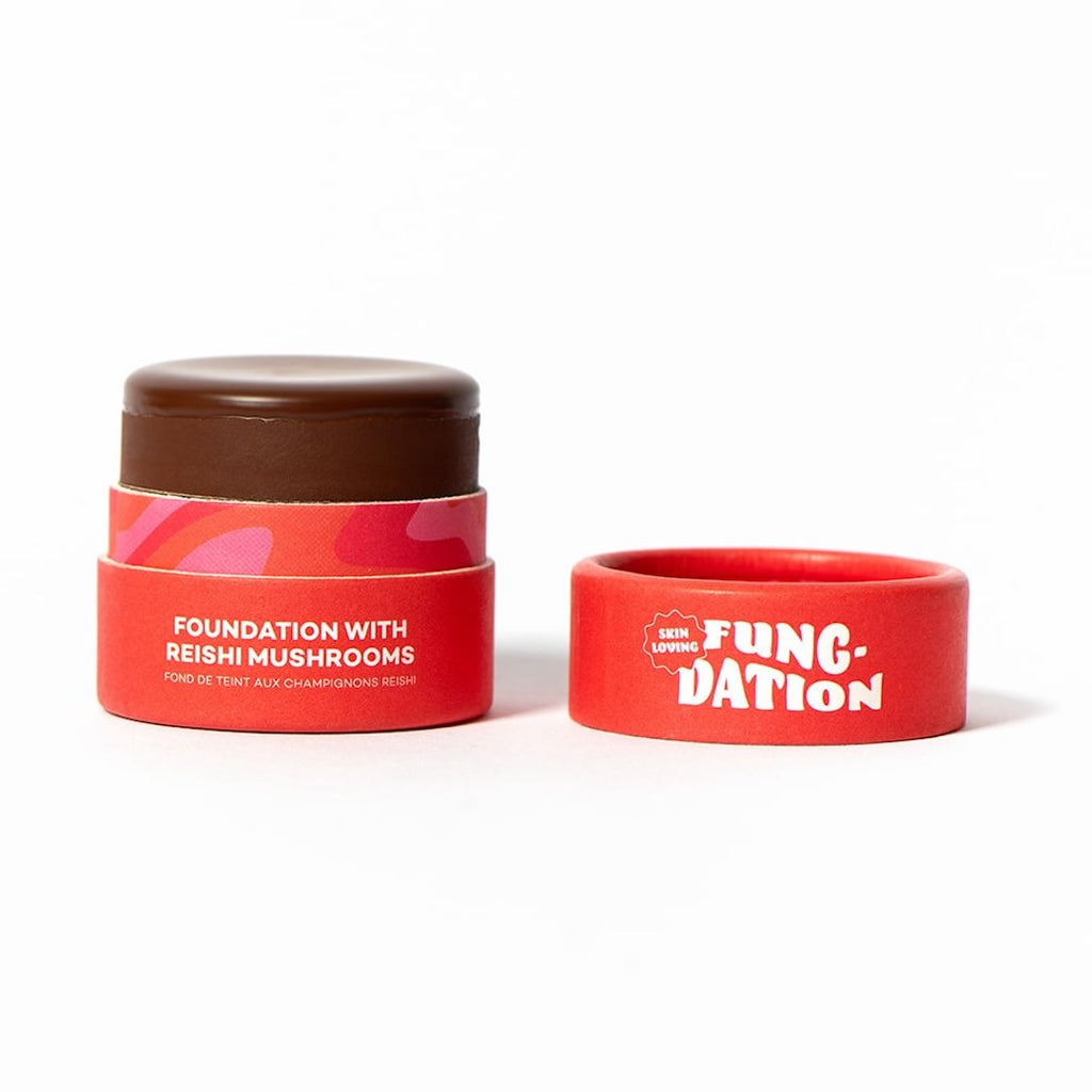 Red pot of foundation with Reishi mushrooms and a red lid labeled 'Fung-Dation' on a white background.