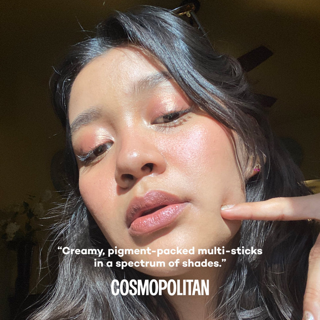 Person with makeup on, pointing to their face with text by Cosmopolitan about product.