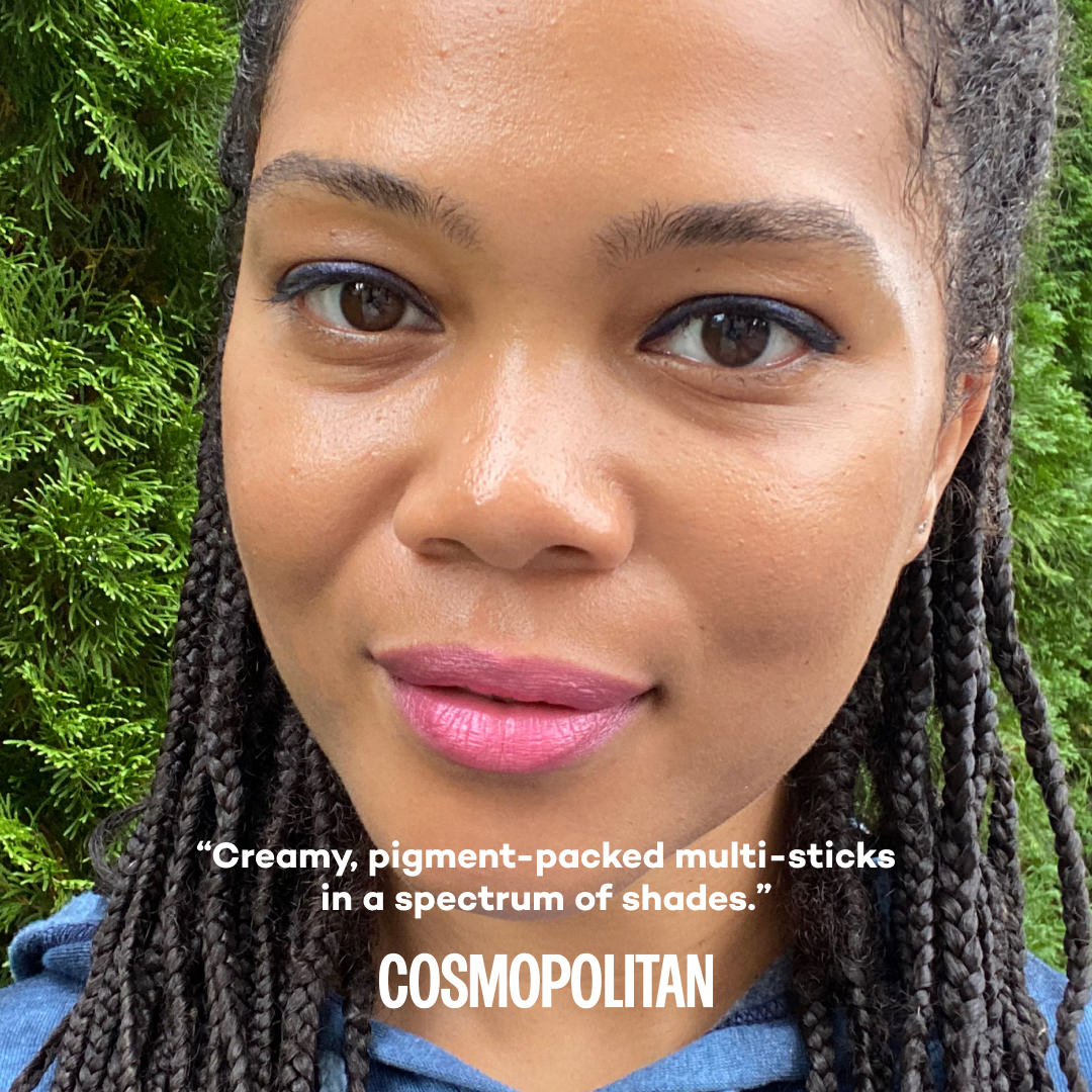Woman with braided hair and pink lipstick against a green background, with text by Cosmopolitan about product.