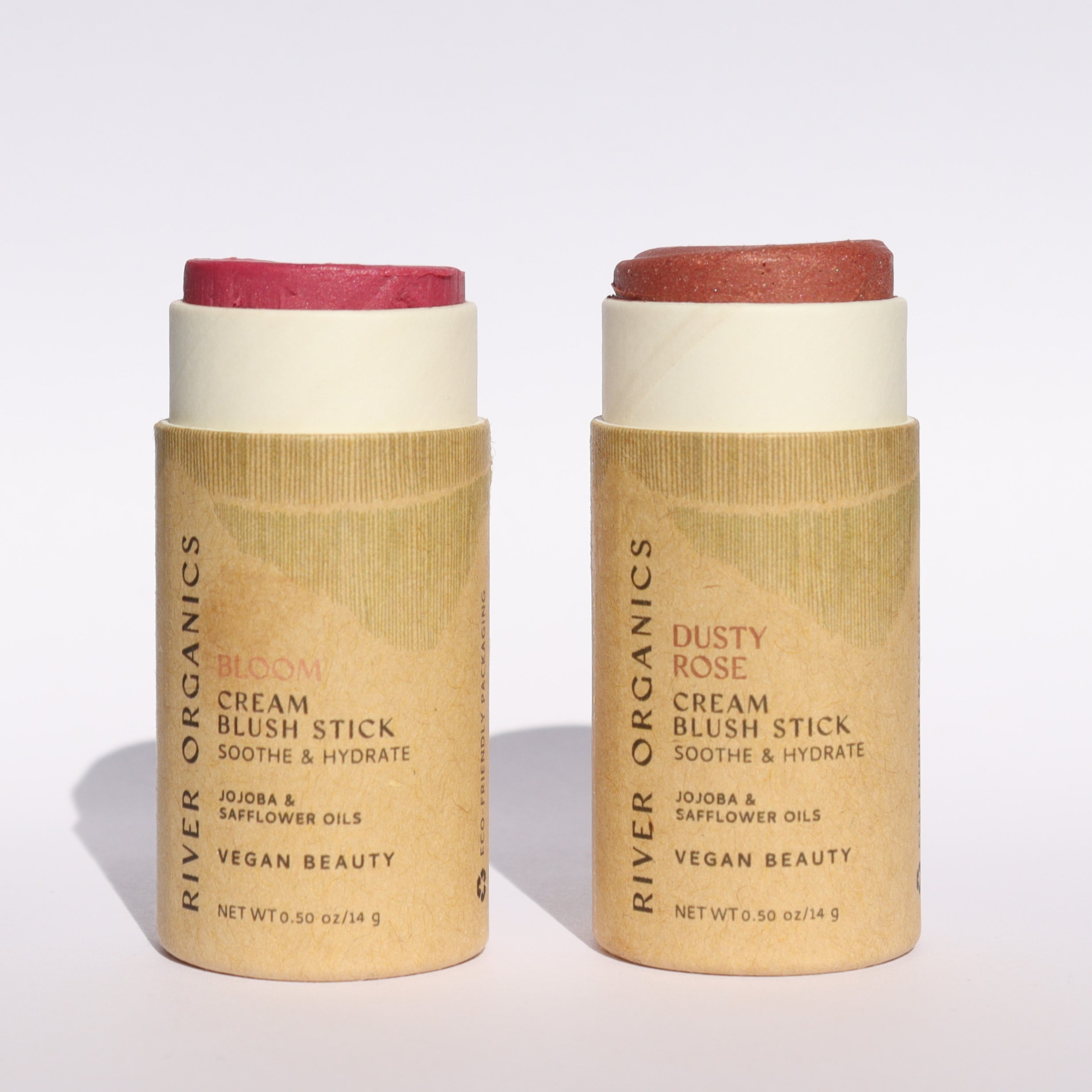 Two cream blush sticks with paper packaging and red blush color on a white background