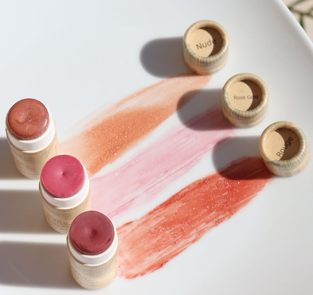 Set of tinted lip balm tubes with visible color swatches on a white surface