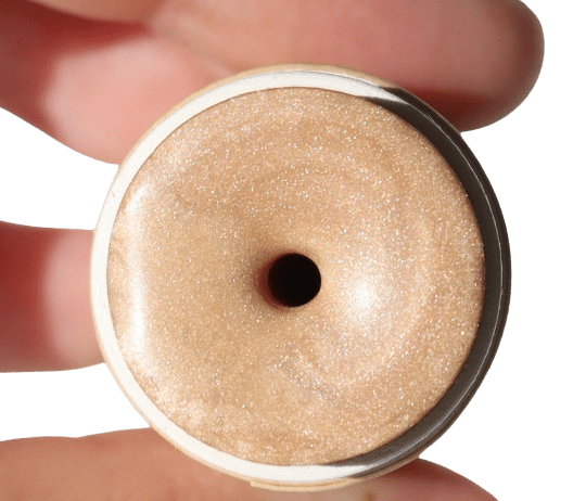 Close-up of a highlighter stick held between fingers against a transparent background