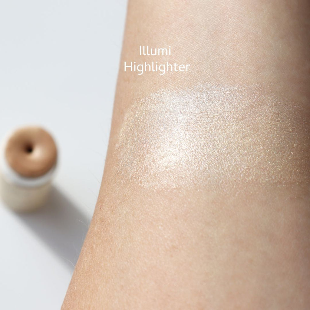 Highlighter swatch applied to skin with 'Illumi Highlighter' text
