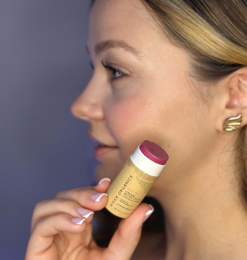 Woman holding a blush stick with a blurred background