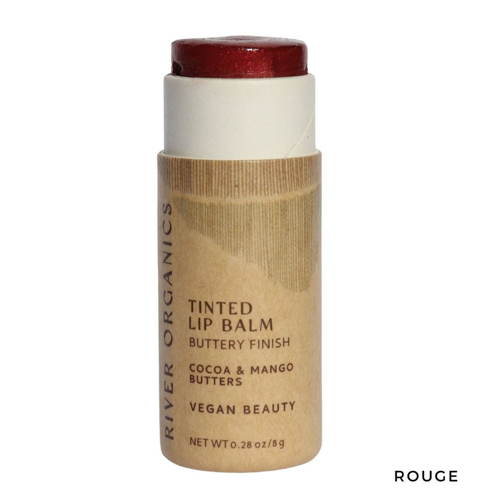 Tinted lip balm stick with brown packaging on a white background