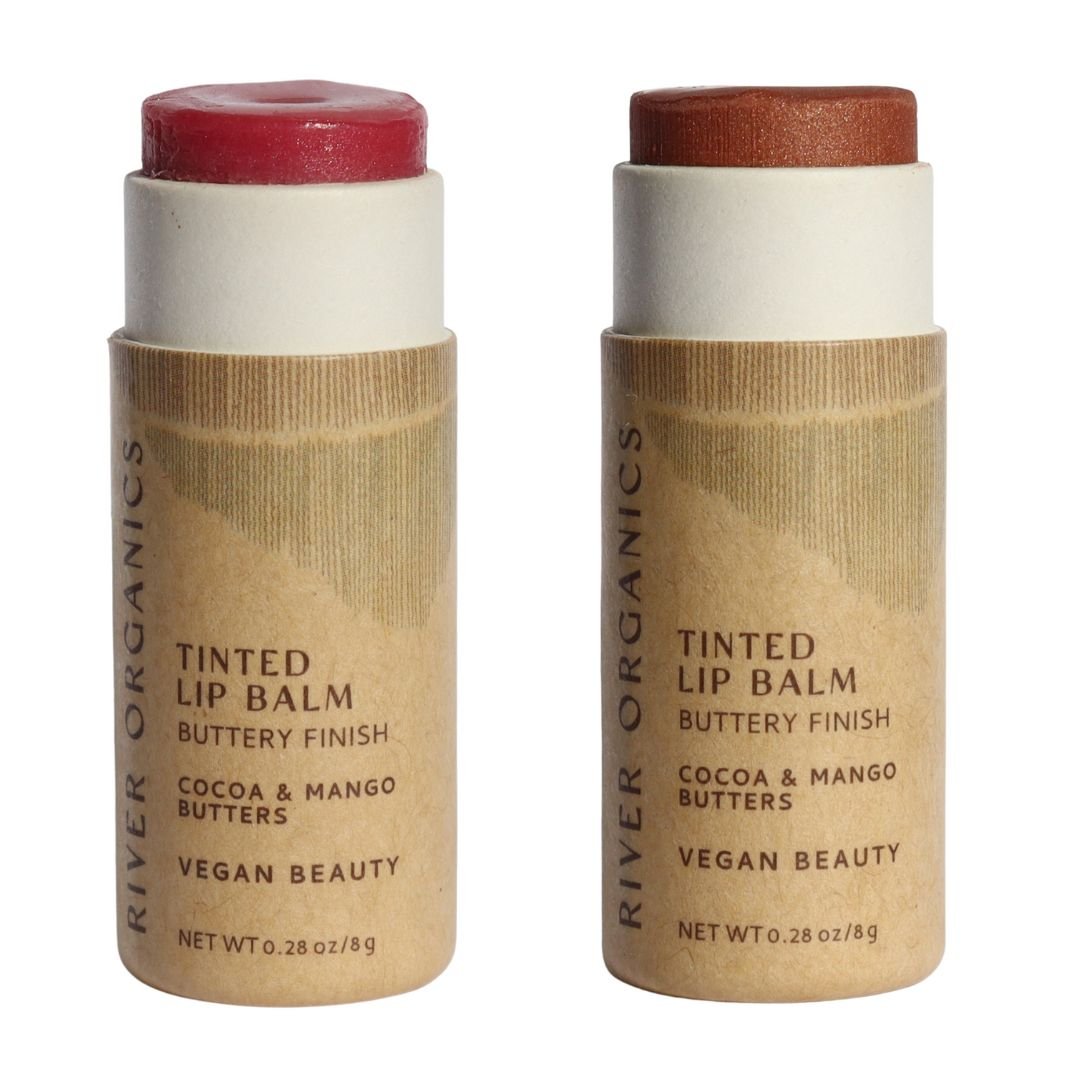 Two River Organics tinted lip balms in paper tubes with a white background.