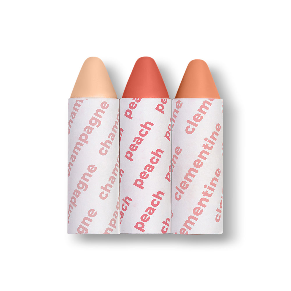 Three lip color sticks with 'champagne', 'peach', and 'clementine' text on white background