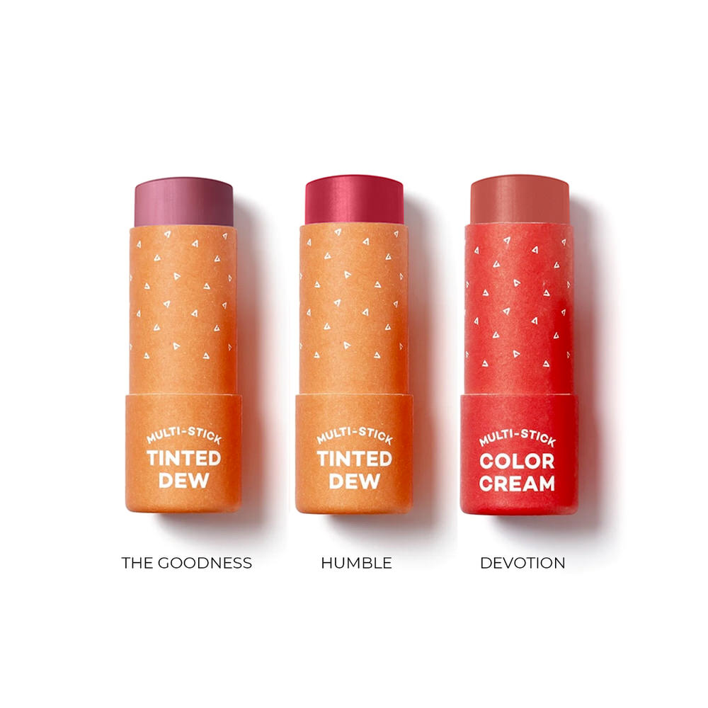 Three multi-stick makeup tubes labeled 'The Goodness', 'Humble', and 'Devotion' on a white background.