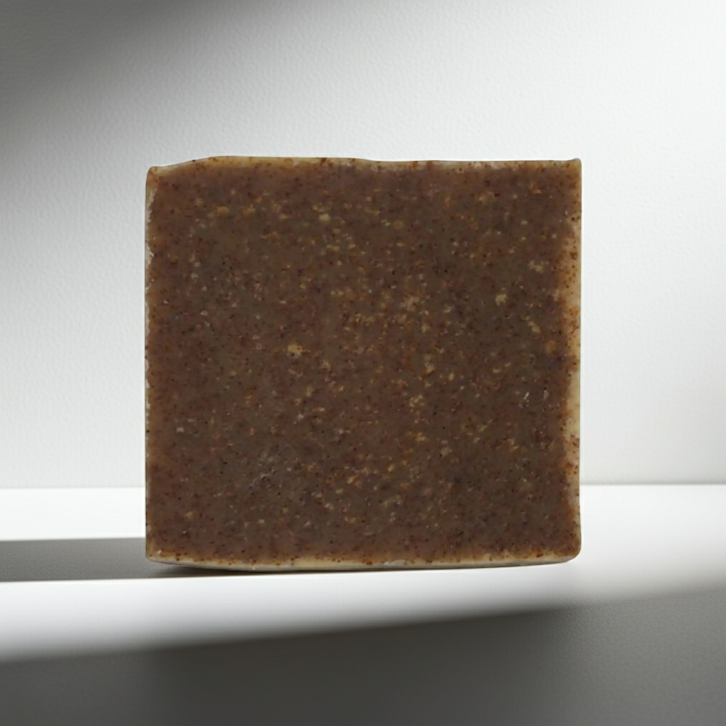 Square bar of brown soap on a light gray background
