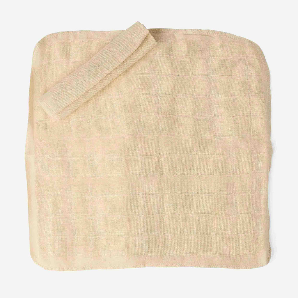 Beige woven washcloth on a white background