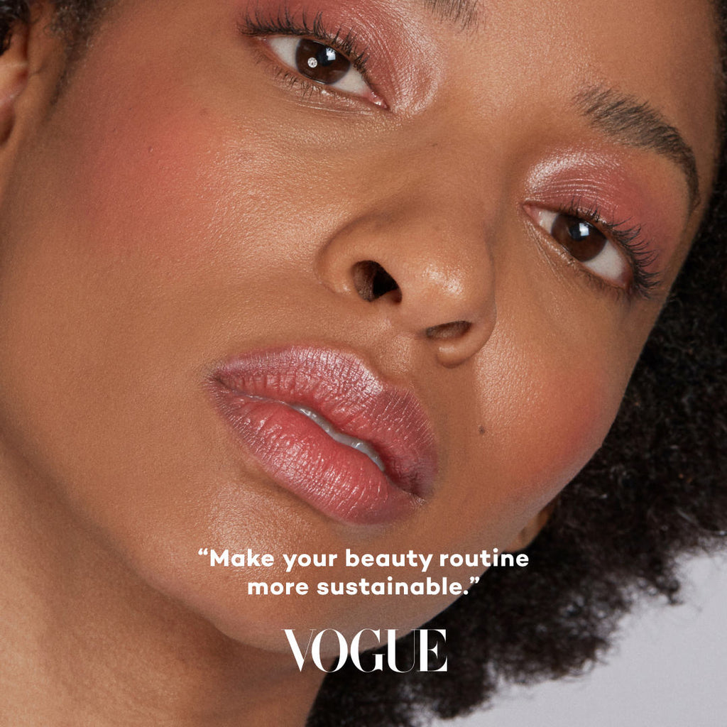 Close-up of a woman's face with makeup, featuring the Vogue logo and text.