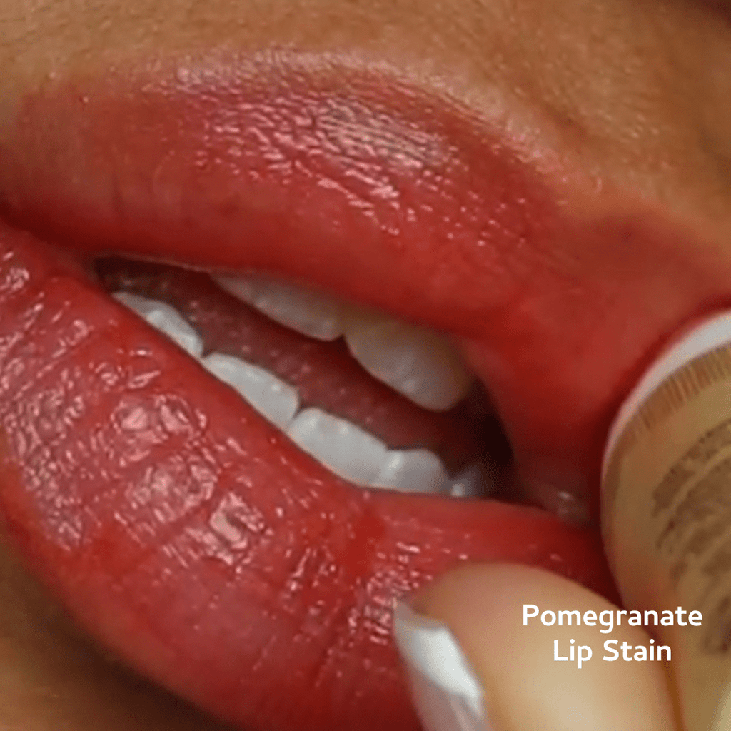 Close-up of lips with pomegranate lip stain and paper tube.