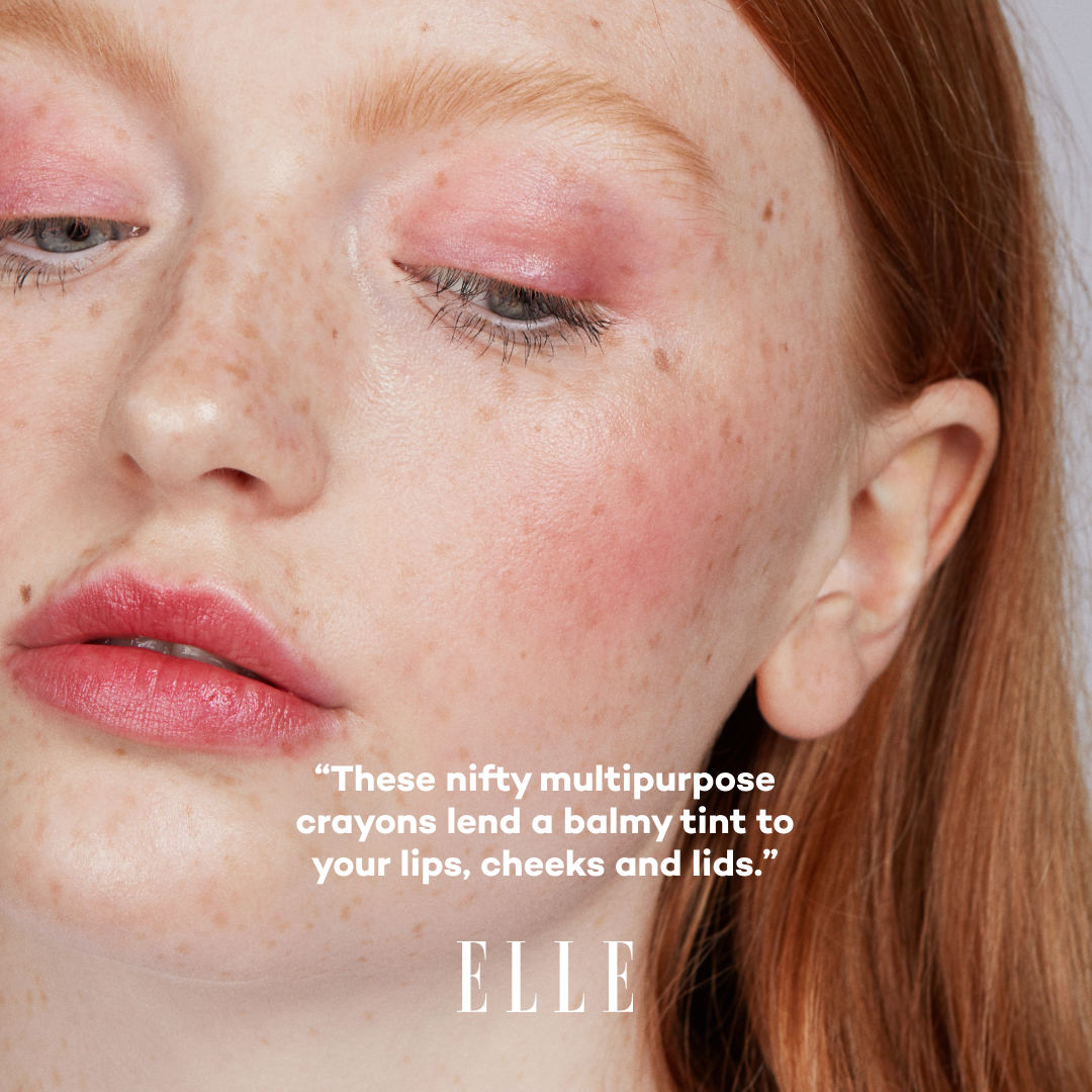 Close-up of a person with pink makeup on cheeks, lips, and eyelids, with 'ELLE' branding.