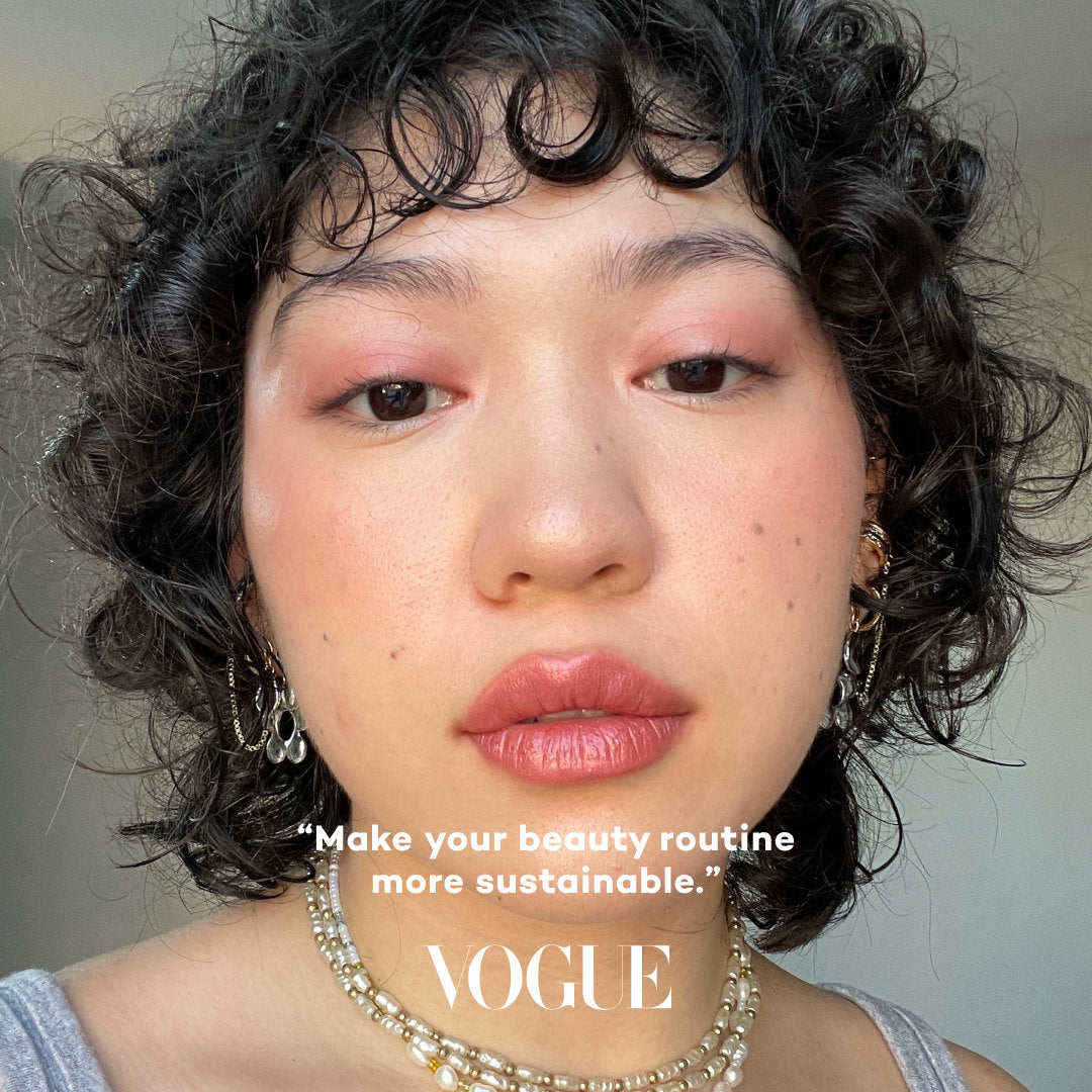 Person with curly hair wearing makeup, with 'Vogue' text overlay.