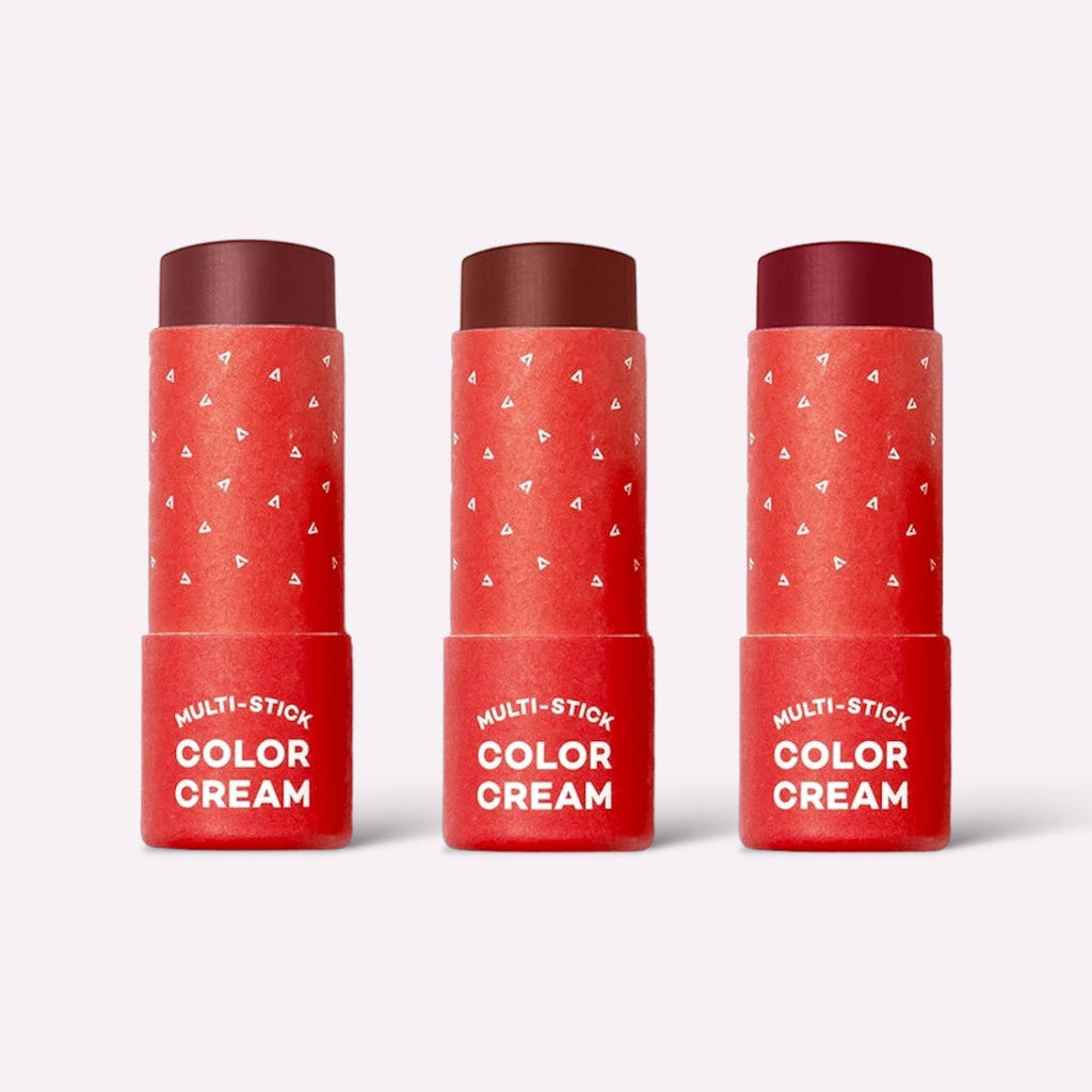 Three red tubes of Multi-Stick Color Cream on a white background
