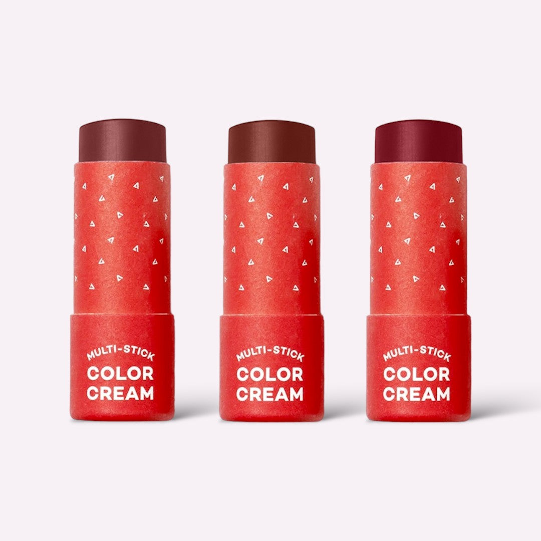 Three red tubes of Multi-Stick Color Cream on a white background