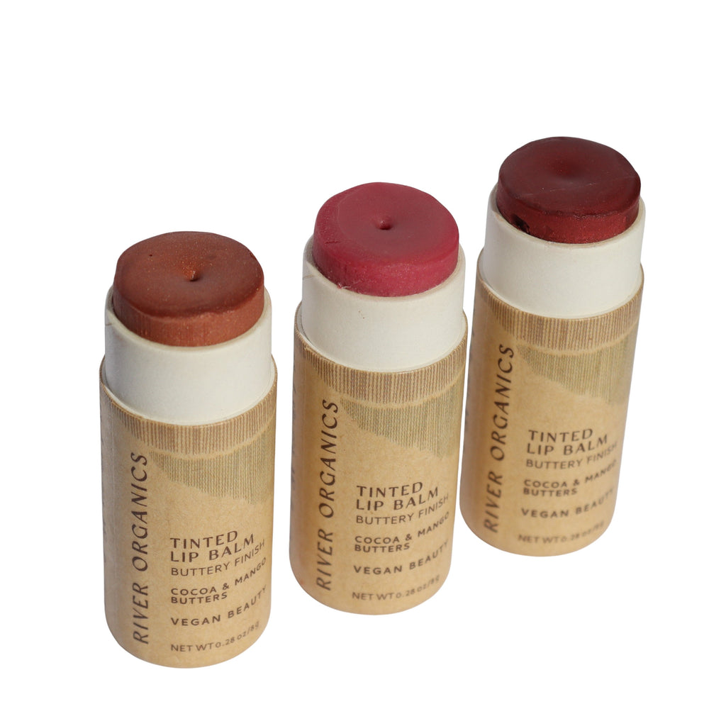 Three River Organics tinted lip balms with paper tubes on a white background