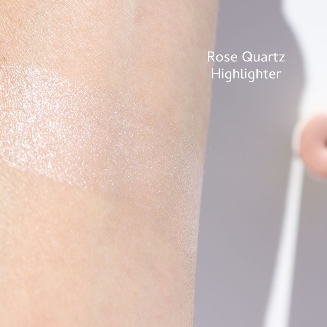 Rose Quartz highlighter swatch on skin with 'Rose Quartz Highlighter' text.