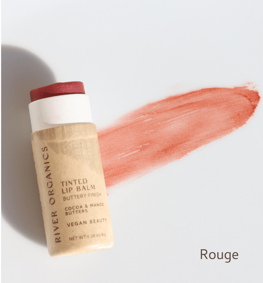 River Organics tinted lip balm with a swatch of color on a light background