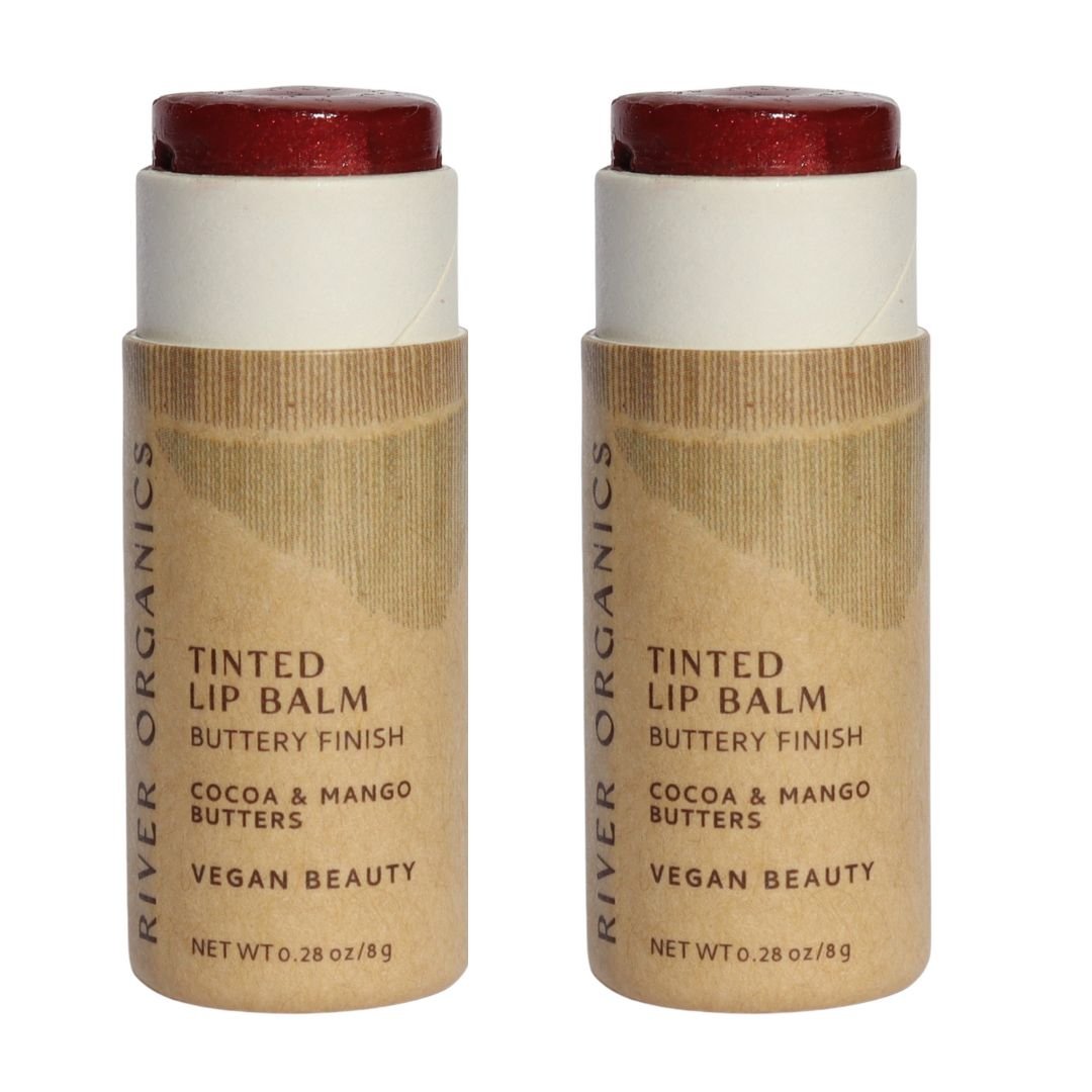 Two River Organics tinted lip balms with brown and white packaging on a white background