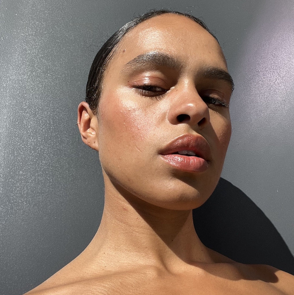 Close-up of a person with a neutral expression against a gray background