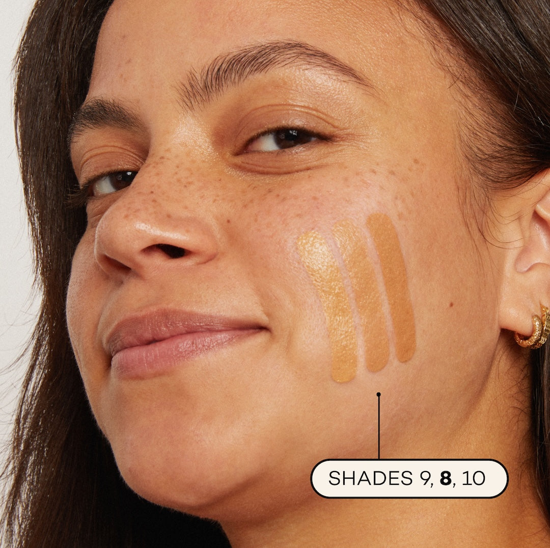Close-up of a woman's face with foundation swatches on her cheek, labeled 'Shades 9, 8, 10'.