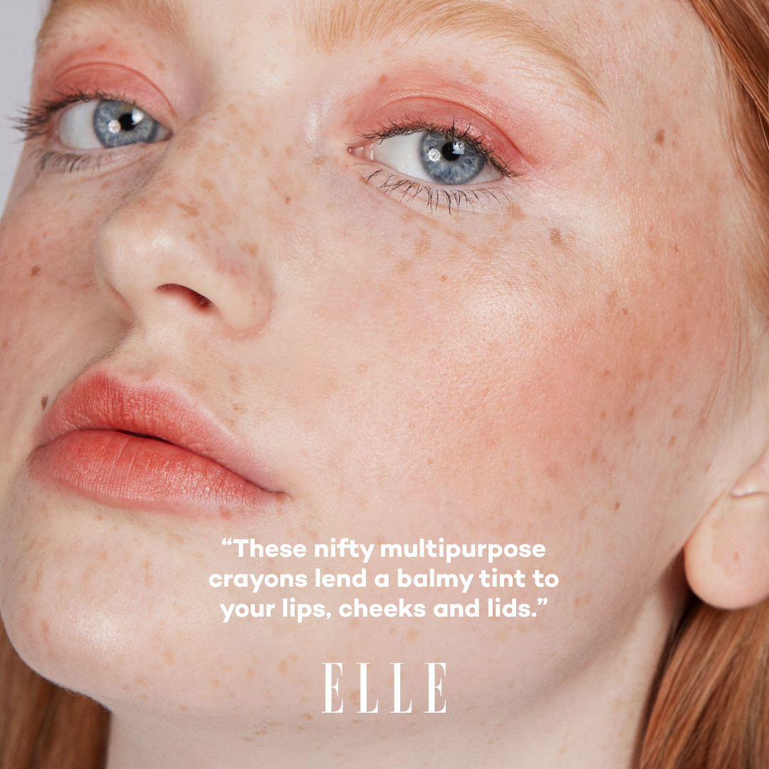 Close-up of a woman's face with makeup application, featuring text from ELLE magazine.