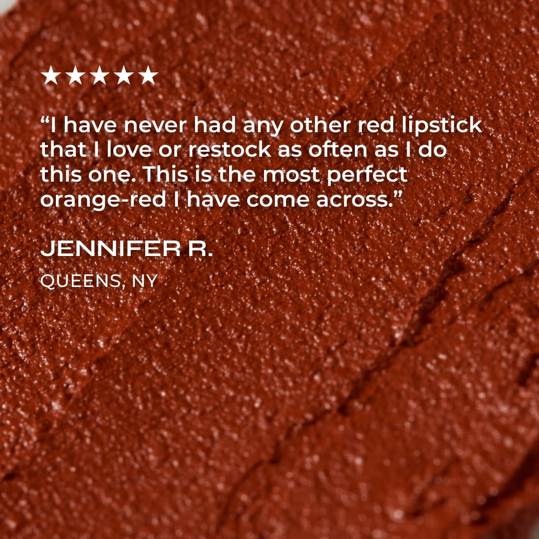 Close-up of a red lipstick with a five-star rating and customer review on a red background.
