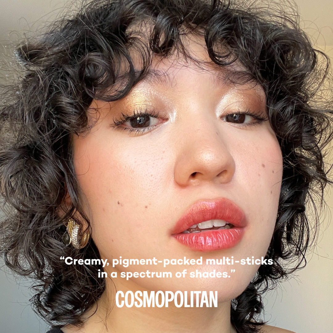 Close-up of a person with curly hair and pink lipstick, with text about cosmetic products.