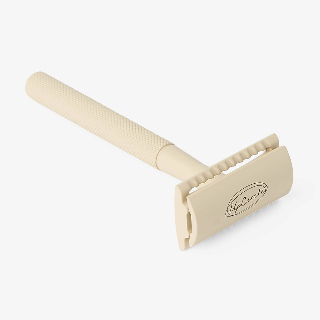 Beige safety razor on a white background