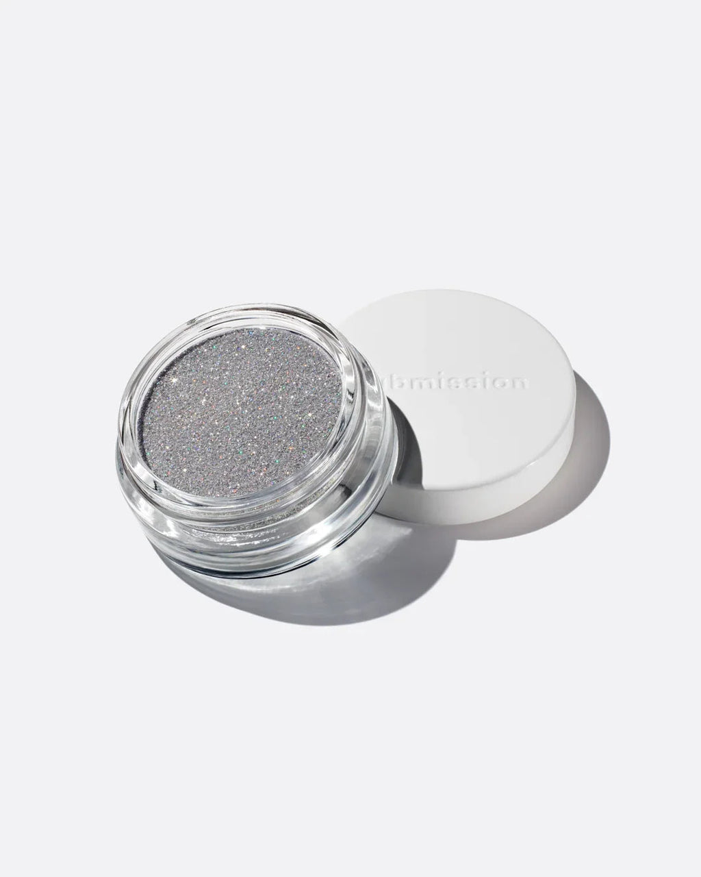 Silver glittery powder in a transparent container with a white lid on a light gray background