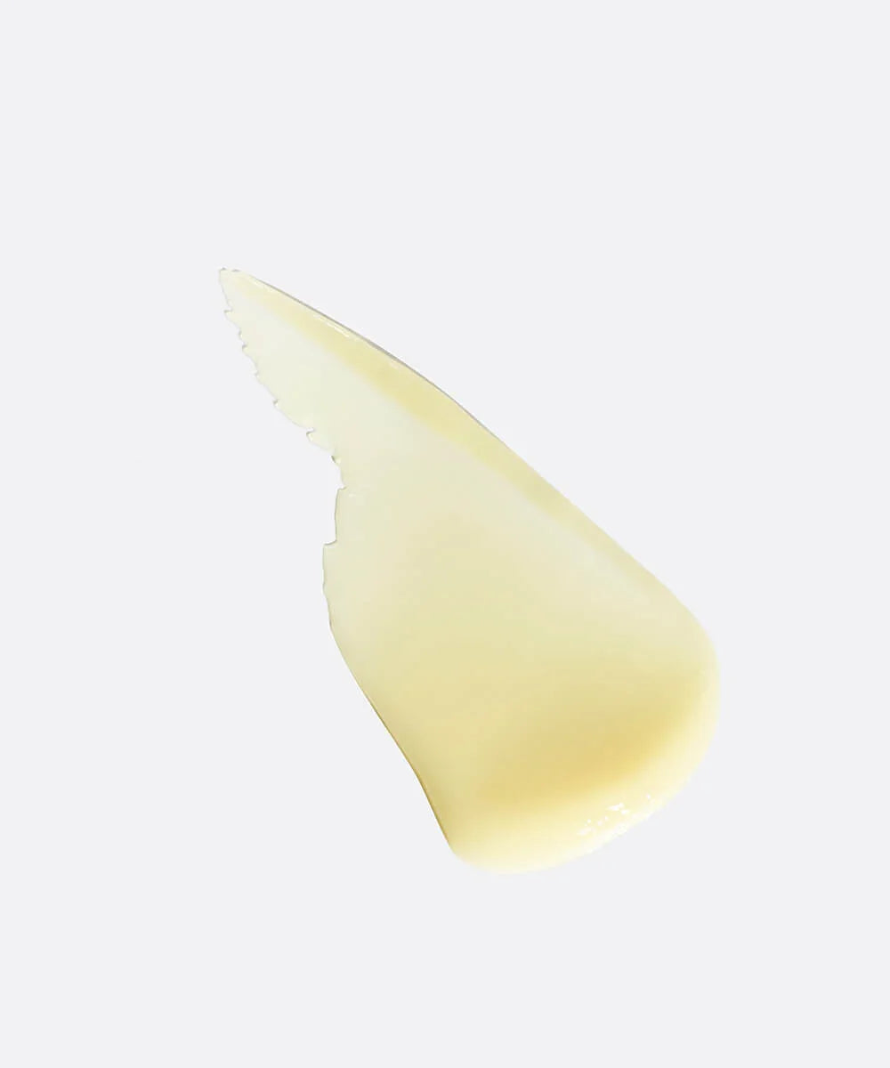 Close-up of a cream cosmetic swatch on a light gray background