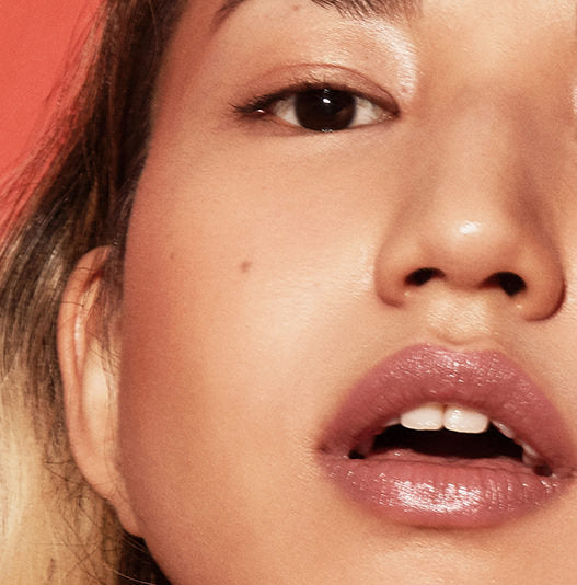 Close-up of a person's face with a focus on the lips and ear.