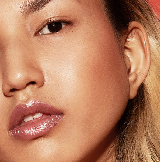 Close-up of a woman's face with a focus on her eye and ear.