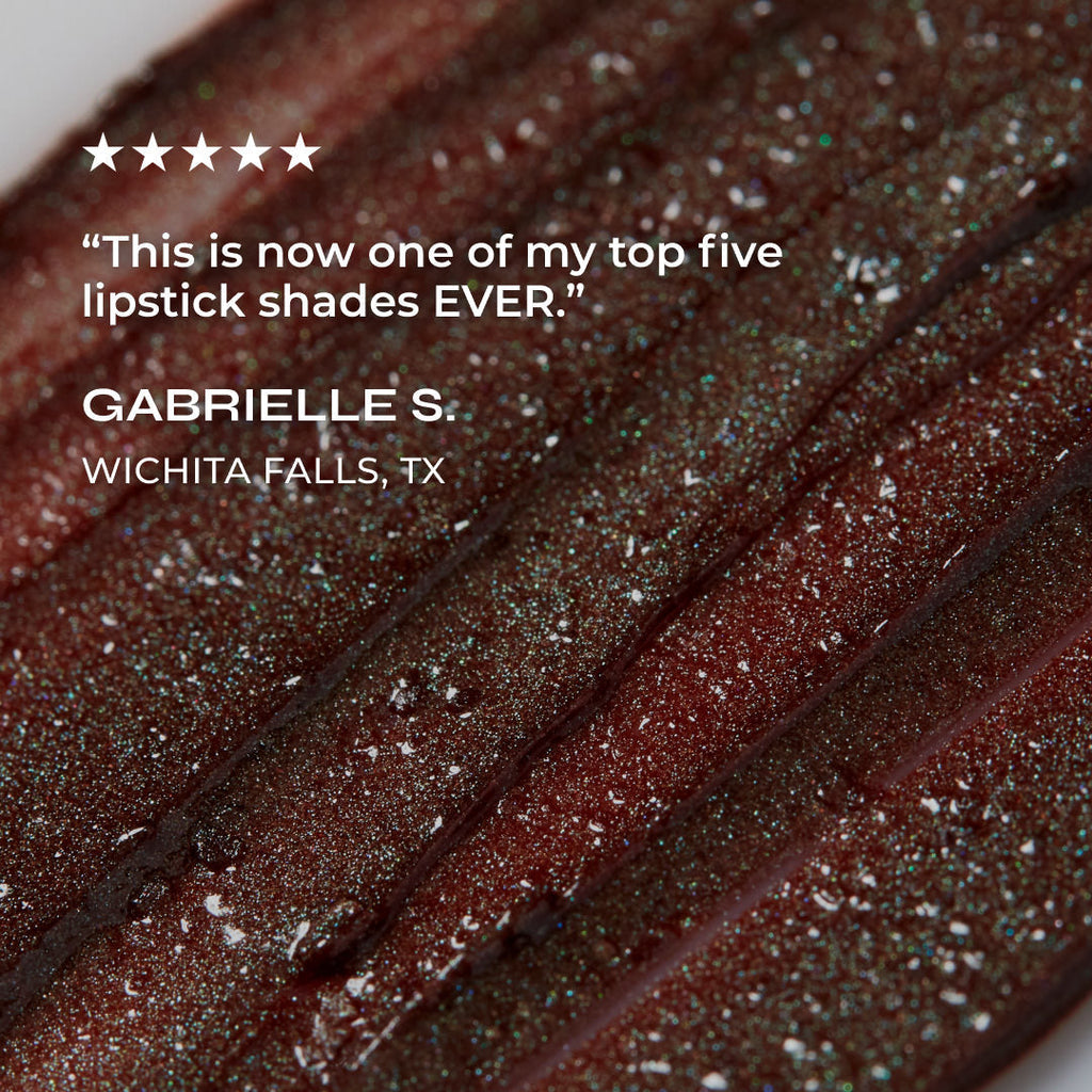 Close-up of a lipstick shade with glitter, featuring a customer review.