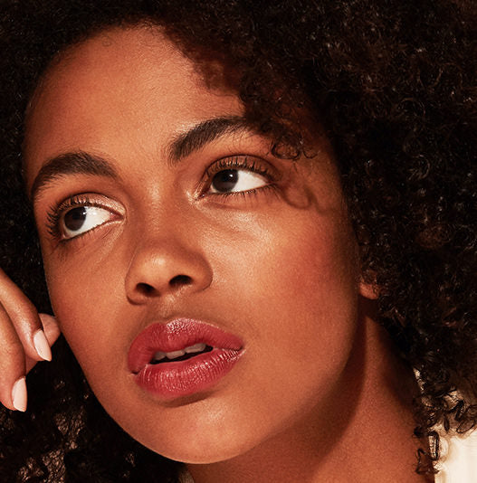 Close-up of a woman wearing makeup with a soft focus background