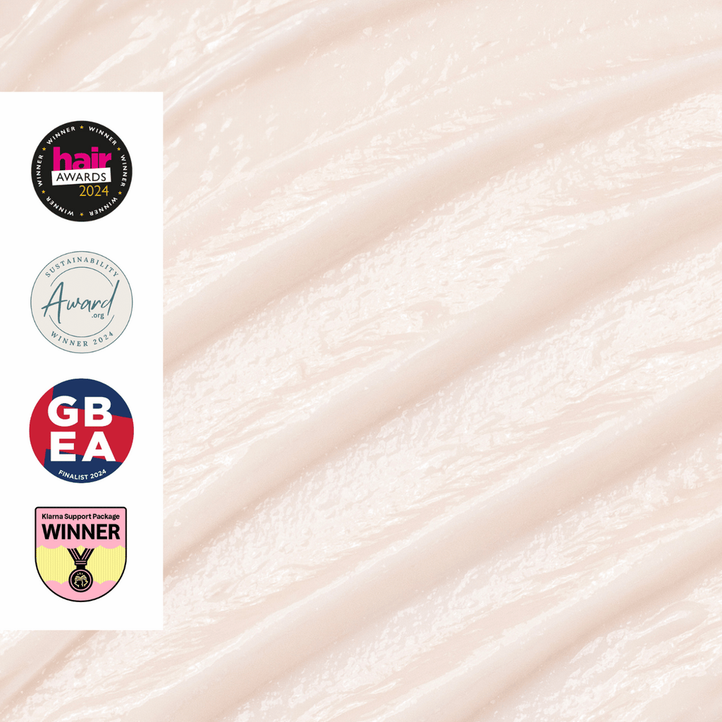 Up-close shot of conditioner creme texture with awards on a white background