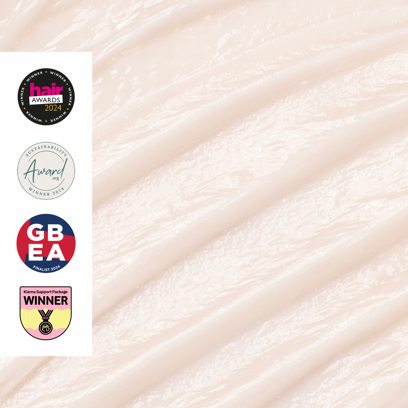 Up-close shot of conditioner creme texture with awards on a white background