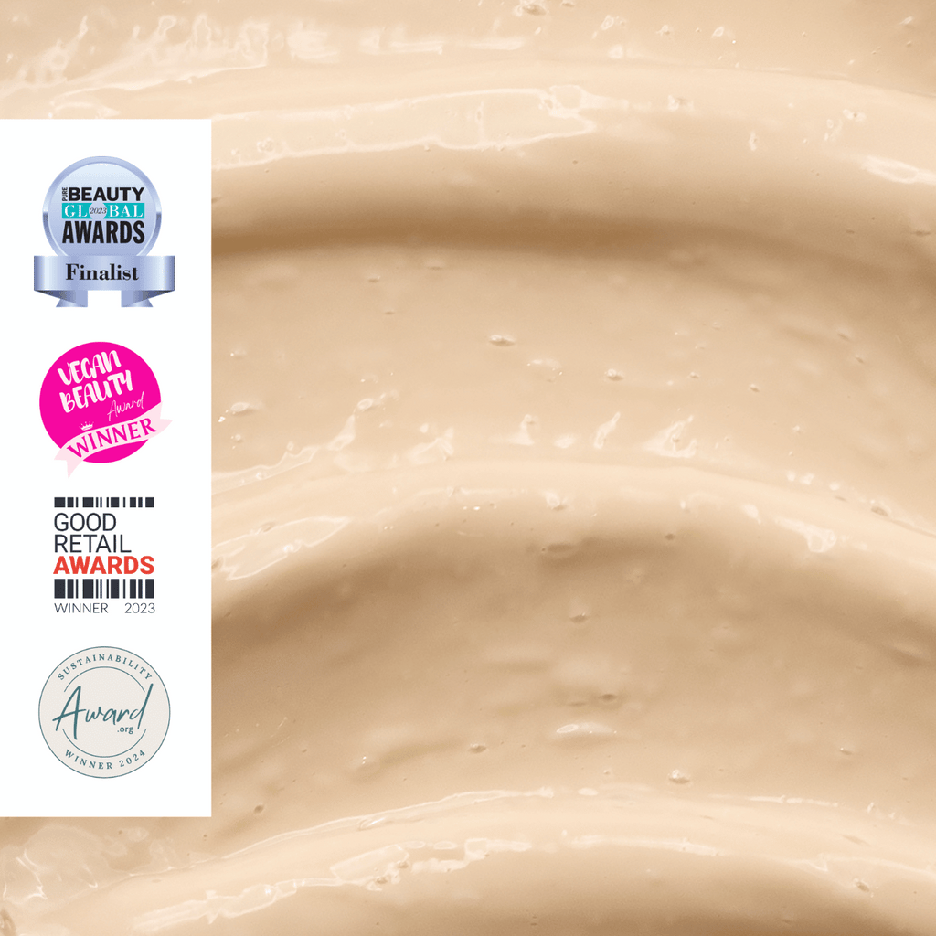 Close up of beige eye cream texture with awards logos on the left side